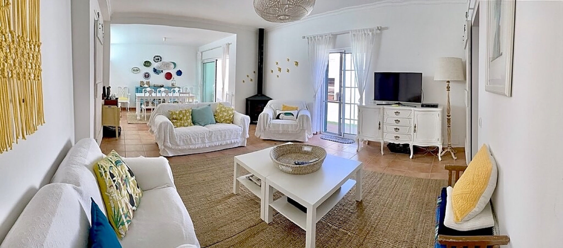 Bright open living room with white sofas