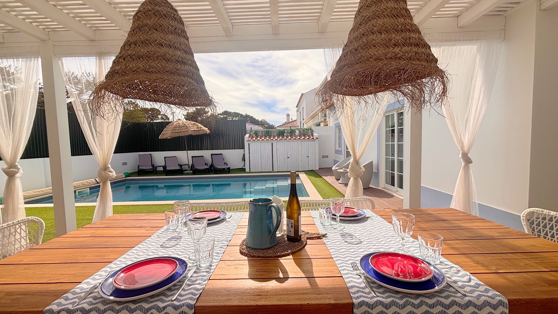 Outdoor table set for lunch beside pool